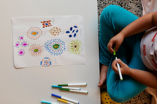 Crop view of little boy with his drawing of flowers