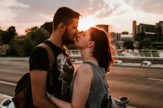 Affectionate young couple embracing at a street at sunset, Berlin, Germany