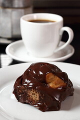 Choux with chocolate ganache and coffee cup