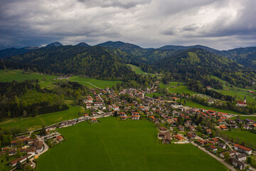 Fototapeta na wymiar Aerial view of the city Bad Wiessee in Germany, Bavaria on a cloudy rainy spring day during the coronavirus lockdown. 