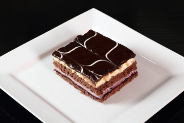 Layer cake with fruit and cream fillings decorated chocolate icing