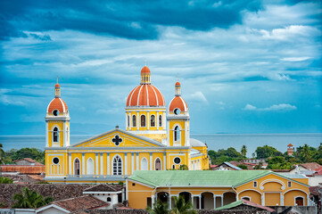 Cathedral of Granada from rooftop, with Lake Nicaragua in the background - obrazy, fototapety, plakaty