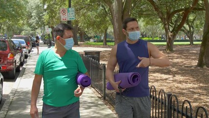 478 Two friends walking to the park to workout during covid19