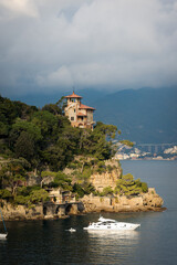 Fototapeta na wymiar Luxury yacht and ancient villa in the port of the famous and ancient village of Portofino. Genoa Province, Liguria, Italy, Europe