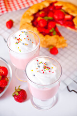 strawberry smoothie milk shake cocktail with whipped cream.