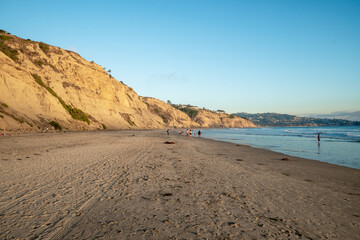 Pacific coastline with yellow sandstone cliffs before sunset time. Black Beach, Black's Beach, San Diego, California, USA