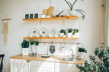the sun's rays fall on the kitchen set, glare from the sun on the dishes, the interior of the dining area, stylish youth design for bright rooms