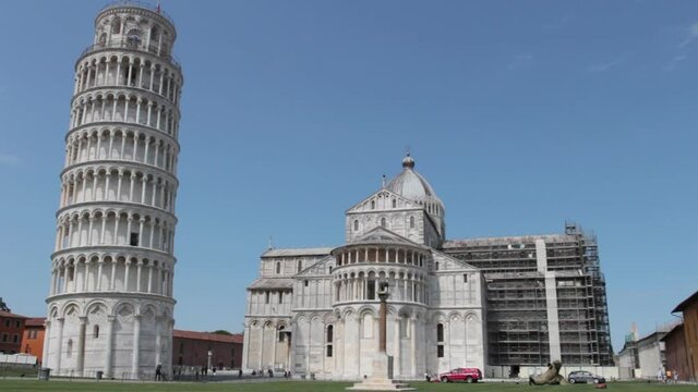 The leaning tower, the cathedral and the Capitoline she-wolf in Piazza dei Miracoli in Pisa