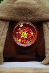 Colorful flowers arranged in a bowl with water for decoration in a spa