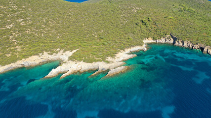 Aerial drone photo of beautiful paradise island complex in gulf of Petalion that form a blue lagoon in South Evia island near Marmari, Greece