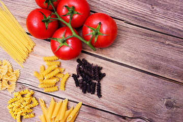 uncooked pasta and spaghetti on a wooden table, texture and background
