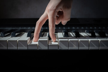 fingers follow the piano keys, the concept of the first steps in music, learning to play a musical...