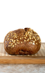 freshly baked bread and soup. Warm homemade freshly cooked lunch. Whole grain loaf and knife on the board
