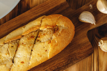 Sliced fresh baguette with garlic oil and herbs
