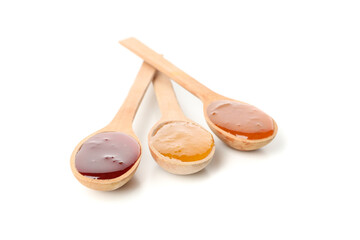 Spoons with jam isolated on white background