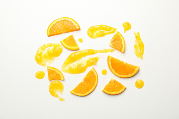 Composition with orange slices and jam on white background