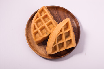 Two waffles in a wooden plate