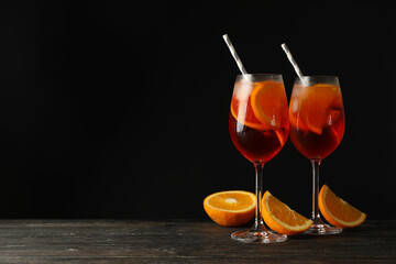 Composition with aperol spritz cocktail against black background