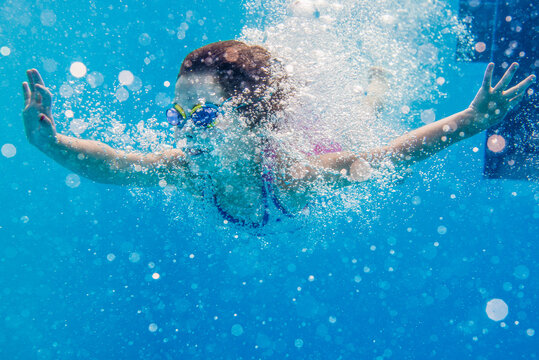 Young girl diving underwater