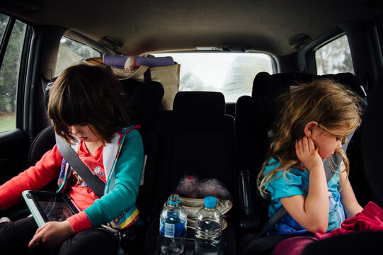 Siblings playing while sitting in car