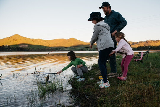 Family fishing at Lake Eildon, netting a carp
