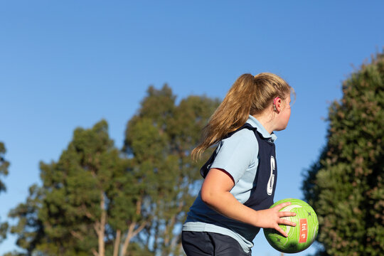 Girl with with hearing aid playing netball