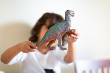 Child with dinosaur toy