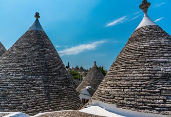 A view of the conical roofs of Trulli buildings in Alberobello, Bari, Italy in the summertime