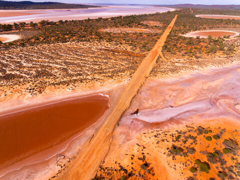 Salt lake with road through outback landscape