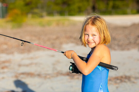 Little girl fishing at the beach