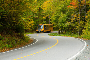 Rickreall, Oregon - 10/7/2015: A school bus navigates a winding forest road on state Highway 22