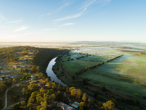 Fog lying over distant farm land and paddocks in early morning