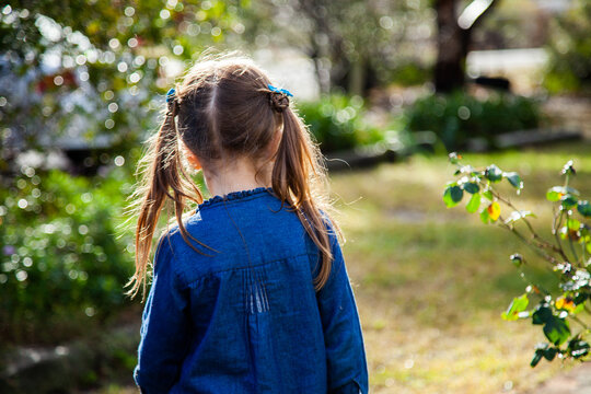 Happy girl playing outside in the garden