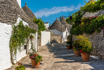 Fototapeta na wymiar A tranquil, picturesque street of traditional Trulli buildings in Alberobello, Italy