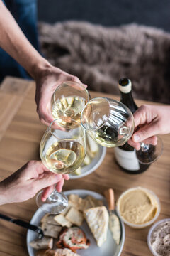 wine toast, three people clinking glasses