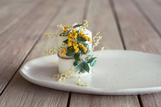 candle with wattle flower