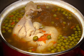 Boiling chicken pea soup in pan