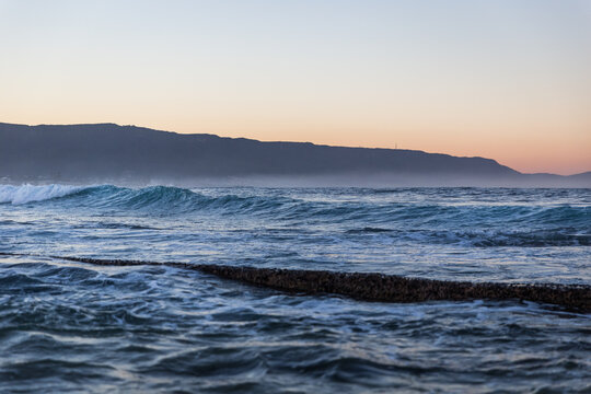 Coastal scene with waves at dusk
