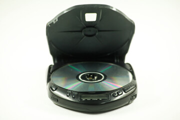 Fototapeta premium old pocket disc player with headphones and an open lid for a laser disc on a white background