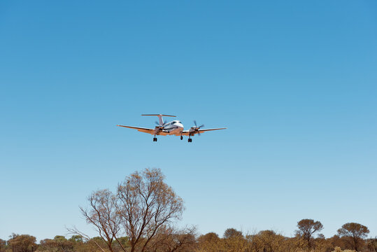 Small charter plane landing at remote air strip