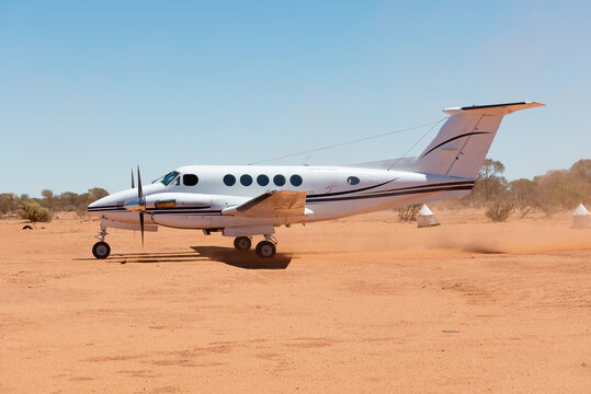 Small charter plane landing at remote air strip