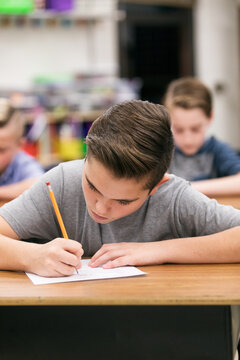 Classroom: Male Student Working Hard In Class