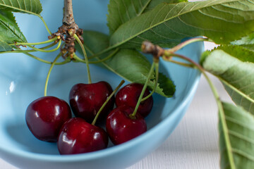 cherries in a blue bowl