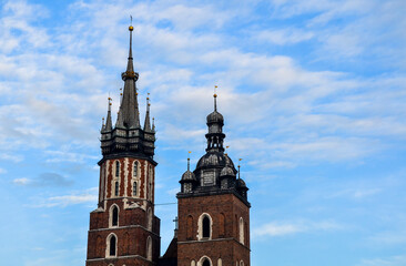 Fototapeta na wymiar The two bell towers with spires of Saint Mary`s Church on main market square in Krakow, Poland