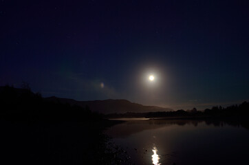 full moon river landscape at night surrounded by mountains
