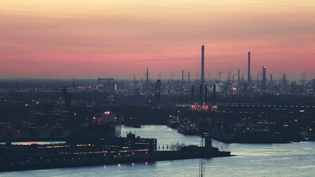 Static footage of loading and unloading docks at the Port of Rotterdam by evening.