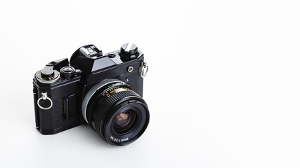 Fototapeta premium Black analogue camera. Isolated white background. Space for text
