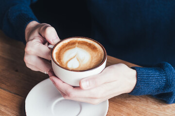 Men hands holding a cup of coffee. Blue sweater, men, cup, coffee, latte, cappuccino, comfort, day.