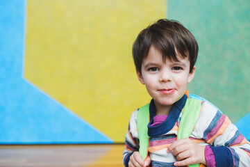 colorful portrait of little boy with backpack