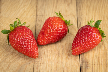 Delicious fresh strawberries on the wooden background. Healthy vegetarian food on farmer market